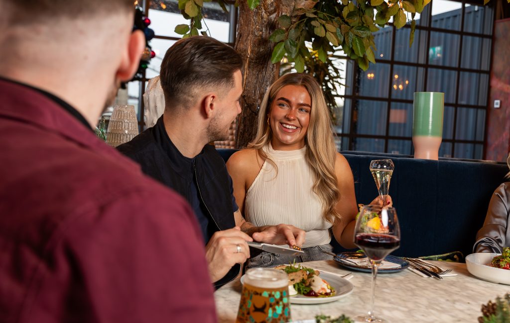 Friends sharing food and drinks around a table